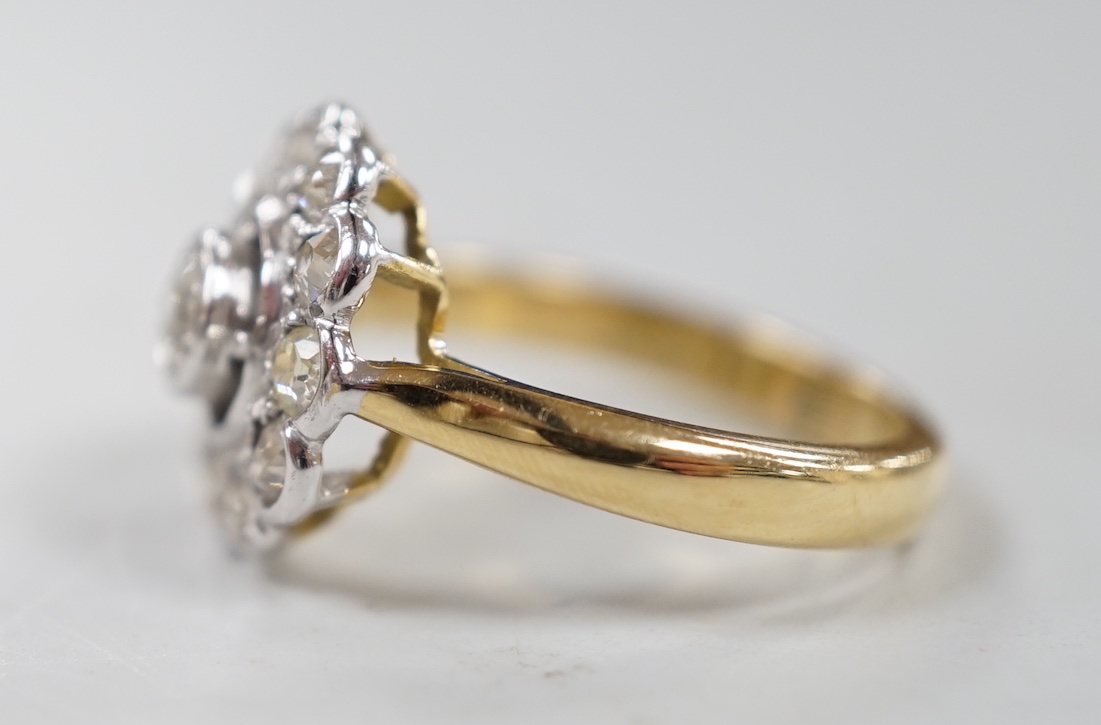 An 18ct and illusion set diamond circular cluster ring, size N, gross weight 5.1 grams.